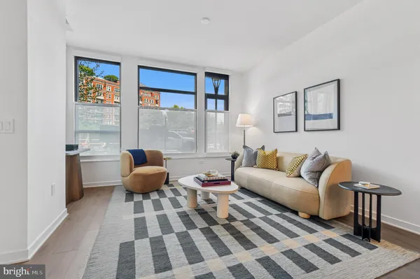 a living room with stainless steel appliances kitchen island a table and chairs