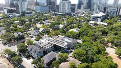 a living room with furniture a rug and a flat screen tv