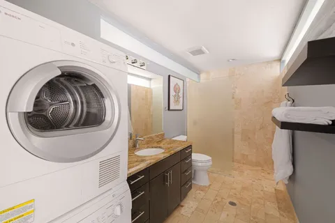 a view of a hallway with washer and dryer