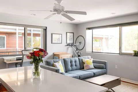 a living room with furniture and a kitchen area
