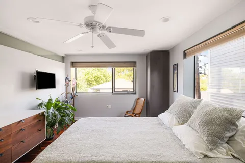 a bedroom with a bed and cupboard