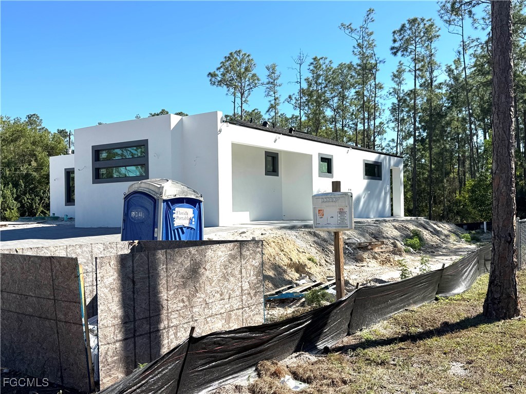 3306 East 2nd Street Lehigh Acres, FL 33936 - Photo 3 of 7 a view of a house with a yard