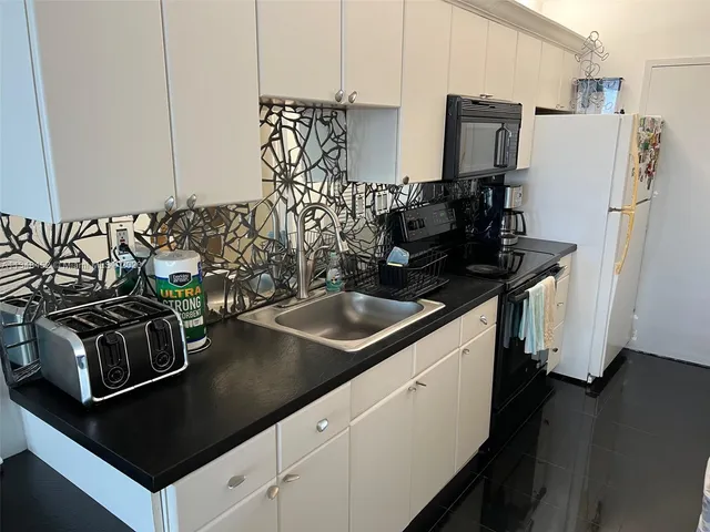 a kitchen with a sink and cabinets