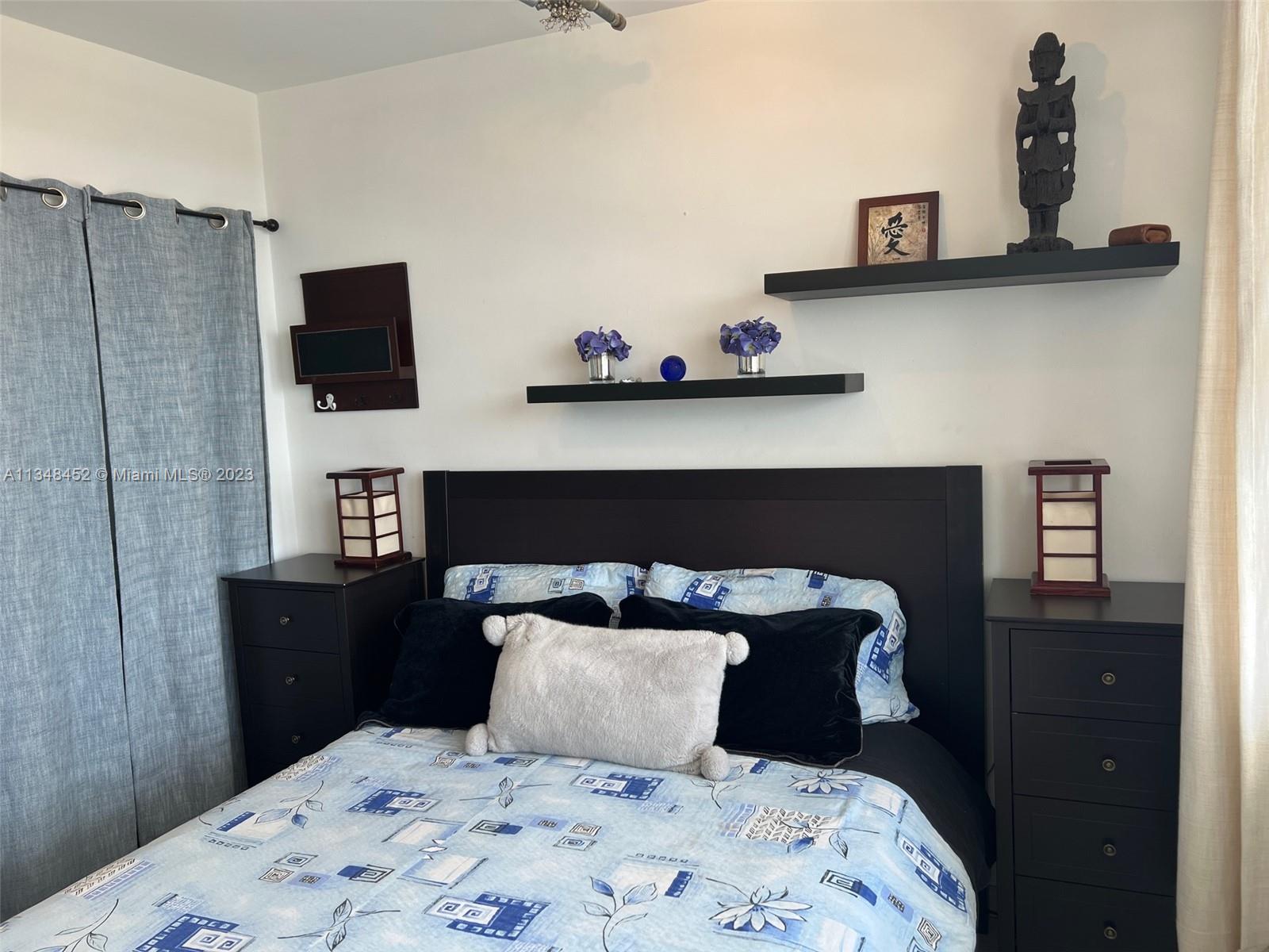 100 Lincoln Road, Unit 1007 Miami Beach, FL 33139 - Photo 17 of 80 a bedroom with bed and night stand