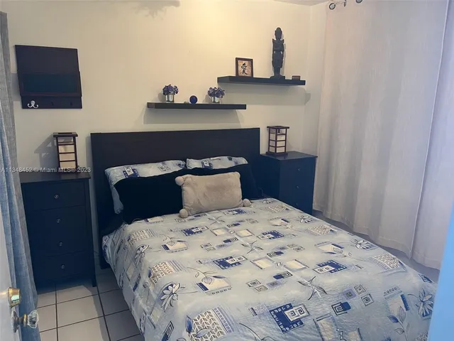 a kitchen with a sink a couch and chairs