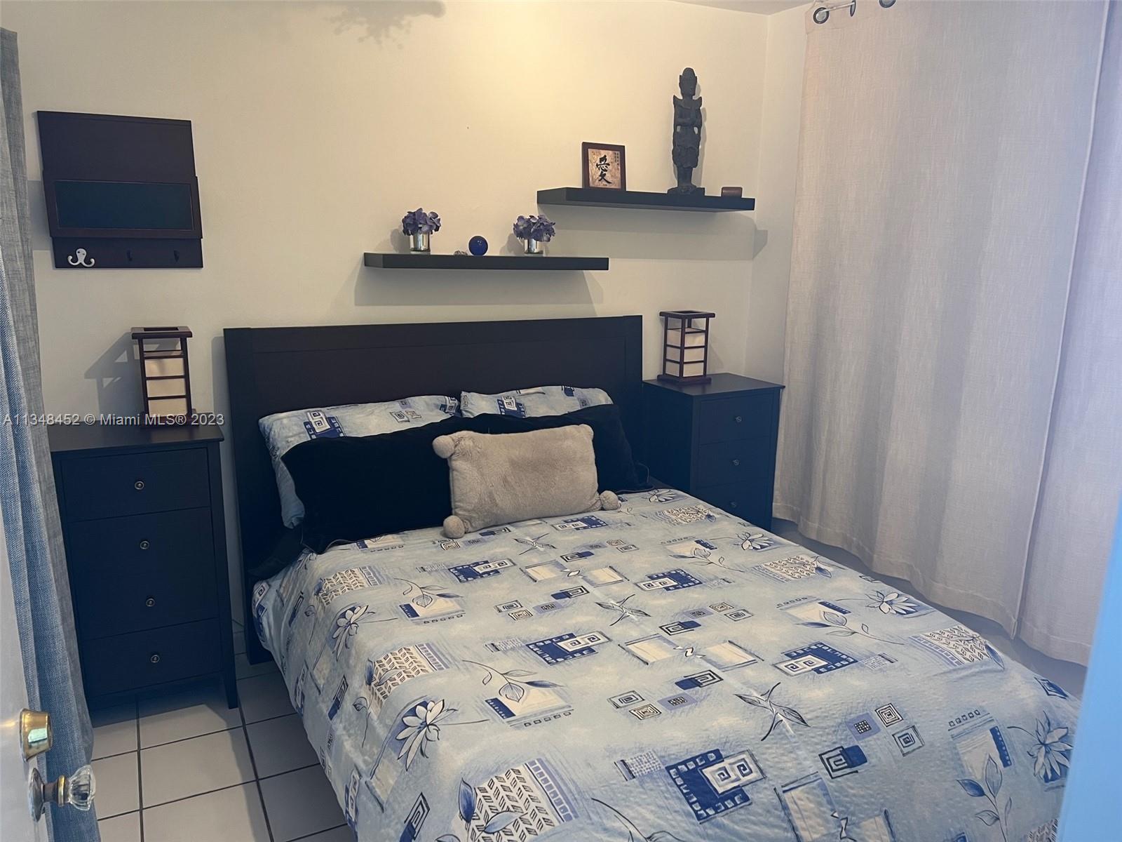 100 Lincoln Road, Unit 1007 Miami Beach, FL 33139 - Photo 18 of 80 a bedroom with a bed and a flat tv screen on dresser