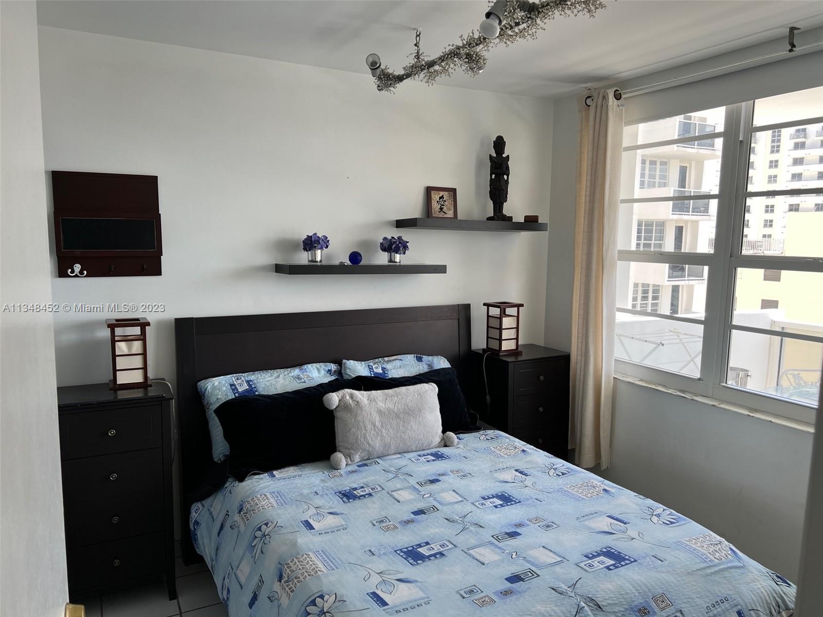 100 Lincoln Road, Unit 1007 Miami Beach, FL 33139 - Photo 19 of 80 a bedroom with a bed and a flat tv screen