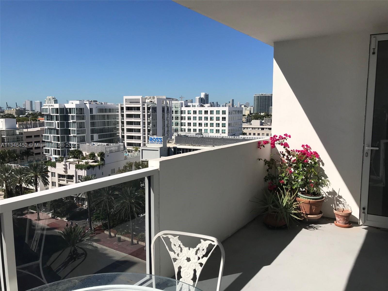 100 Lincoln Road, Unit 1007 Miami Beach, FL 33139 - Photo 2 of 80 a balcony with wooden floor and outdoor seating