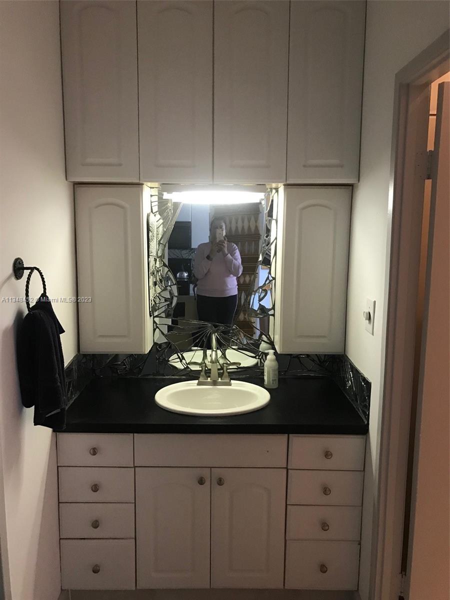 100 Lincoln Road, Unit 1007 Miami Beach, FL 33139 - Photo 21 of 80 a kitchen with a sink and cabinets