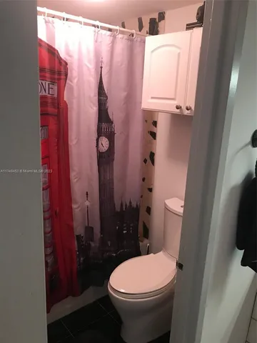a bathroom with a sink toilet and mirror