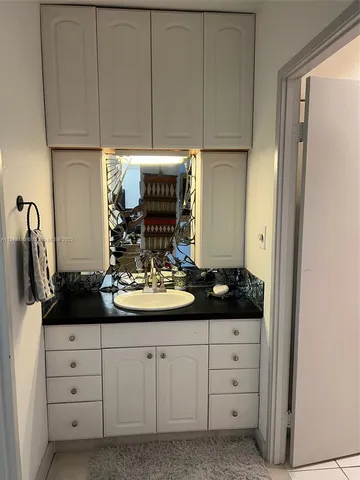 an aerial view of a house with lots of residential buildings ocean and mountain in back