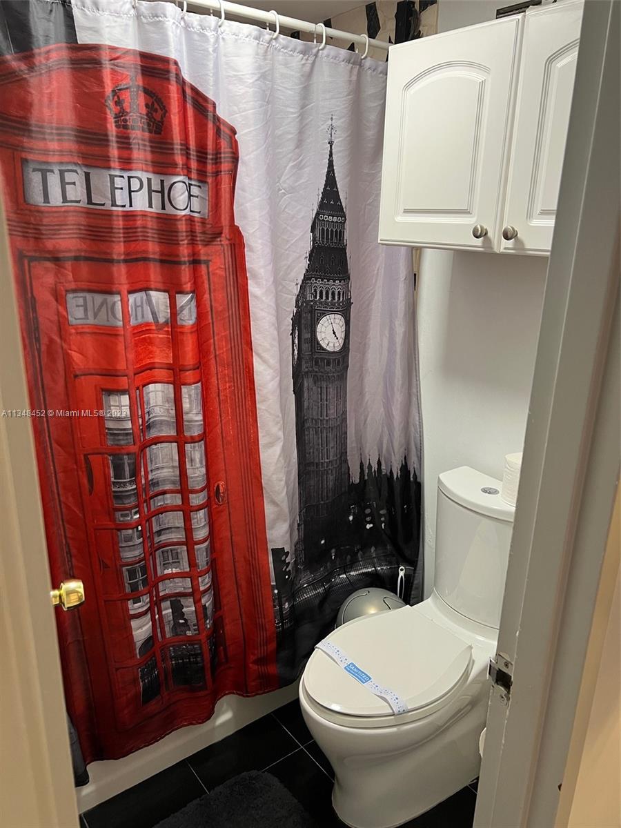100 Lincoln Road, Unit 1007 Miami Beach, FL 33139 - Photo 25 of 80 a bathroom with a toilet and a shower curtain