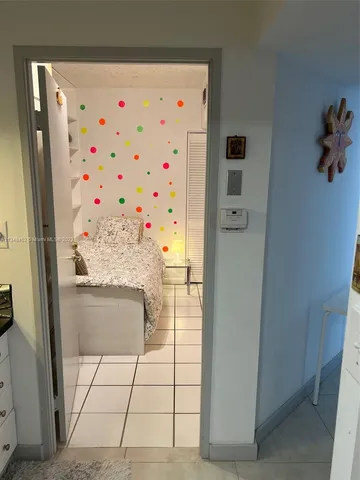 a living room with furniture potted plant and a wooden floor