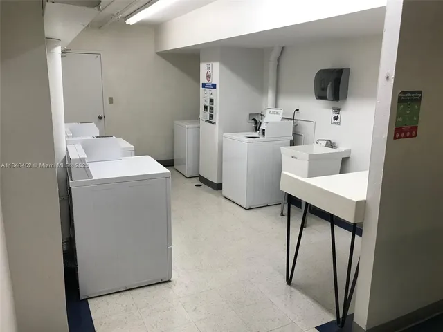 a room with gym equipment and large mirror