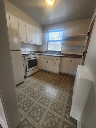 a kitchen with a stove a sink and a refrigerator