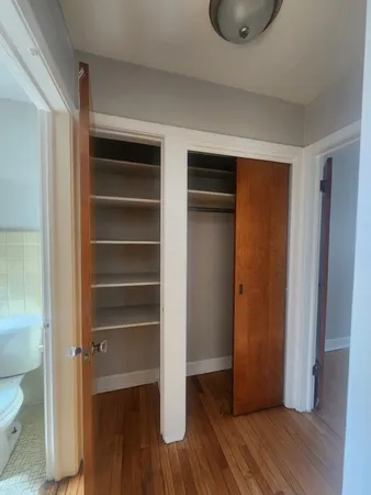 a view of walk in closet with empty racks