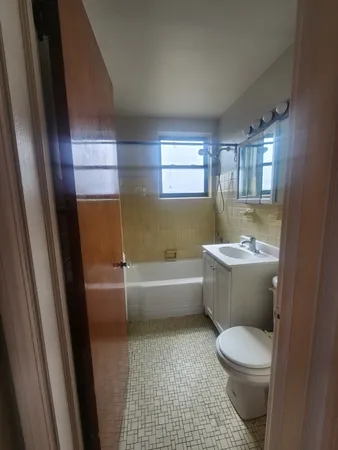 a bathroom with a sink a toilet and bathtub