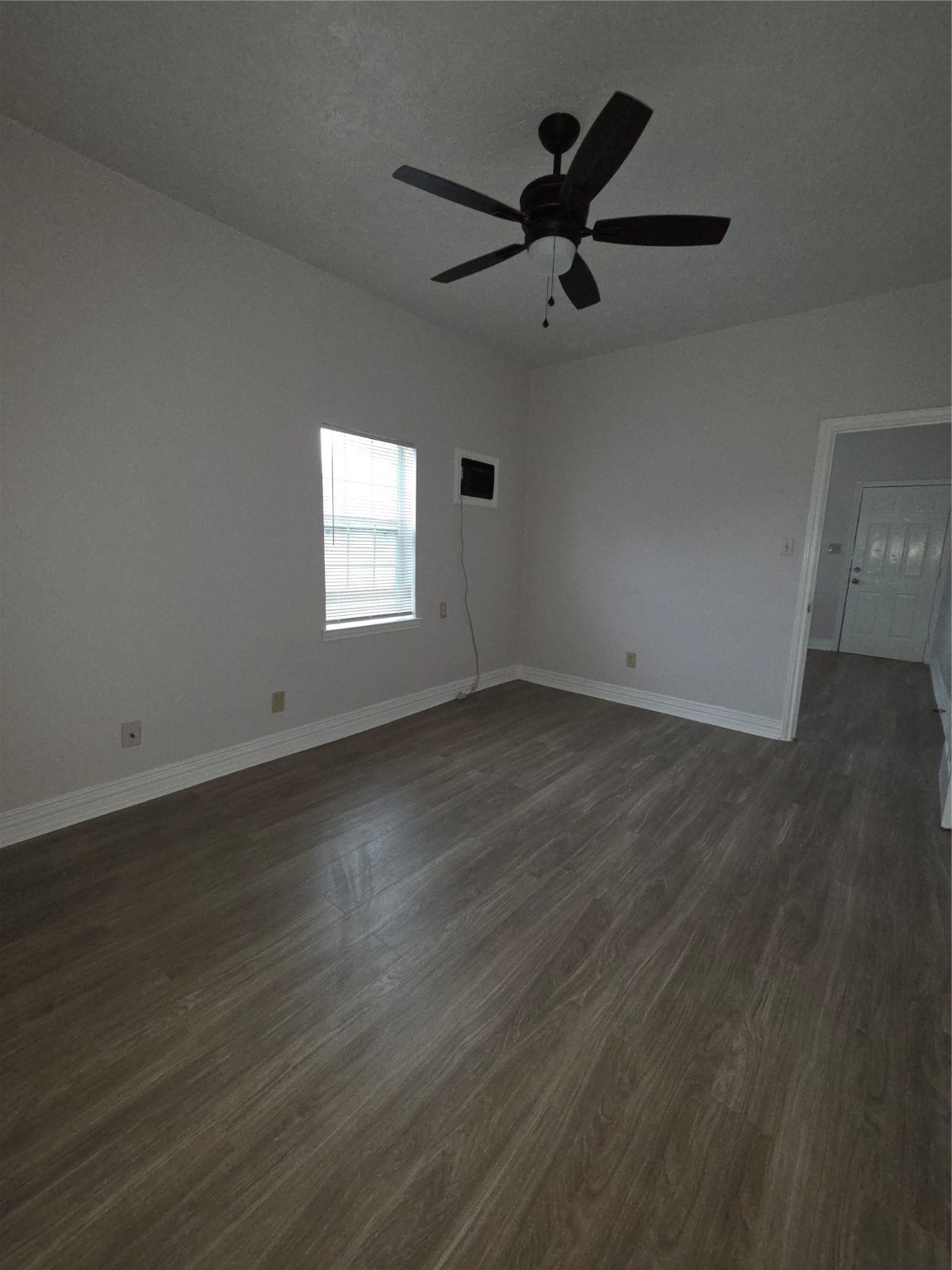 7902 Hudson Street, Unit A Houston, TX 77012 - Photo 3 of 8 an empty room with wooden floor and windows