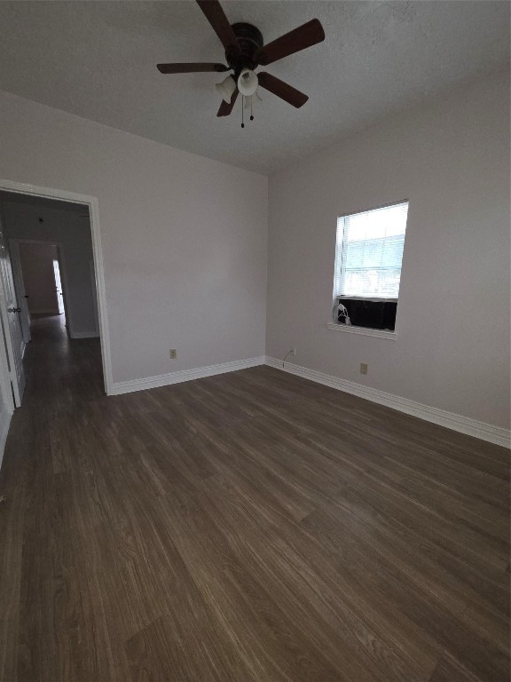 7902 Hudson Street, Unit A Houston, TX 77012 - Photo 4 of 8 an empty room with wooden floor and windows