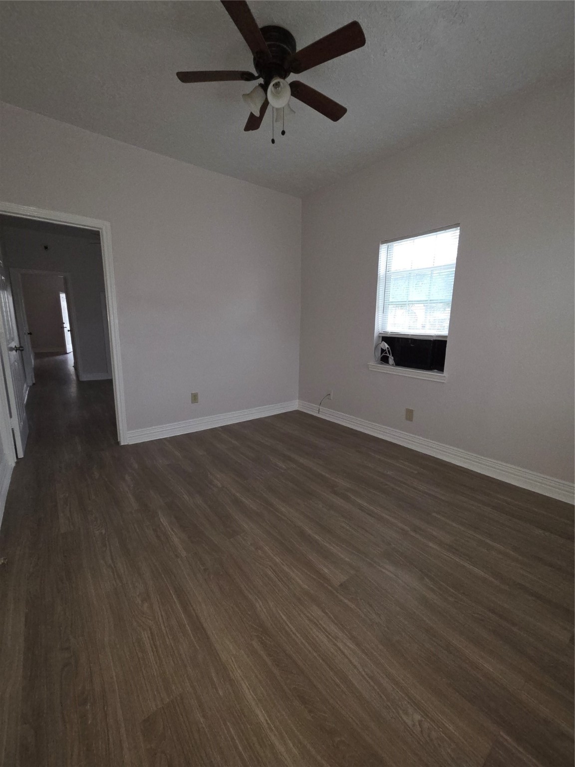 7902 Hudson Street, Unit A Houston, TX 77012 - Photo 4 of 8 an empty room with wooden floor and windows