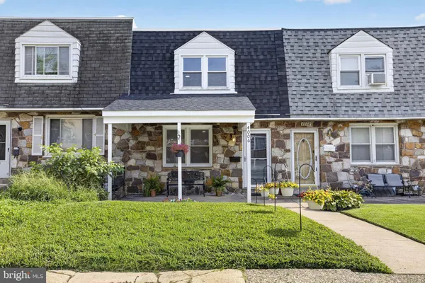front view of a brick house with a yard