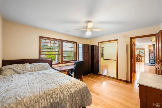 a bedroom with a bed and a large window