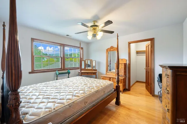 a bed sitting in a bedroom next to a window