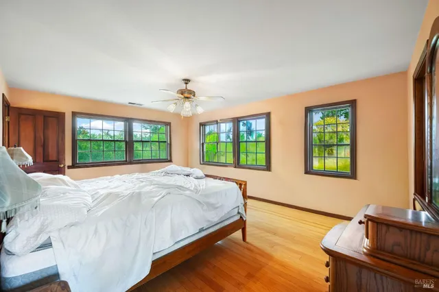 a bedroom with a bed and a chair