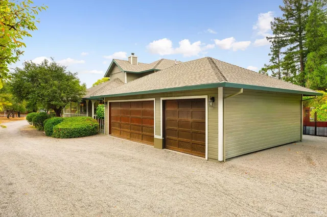 a view of a house with a yard and garage