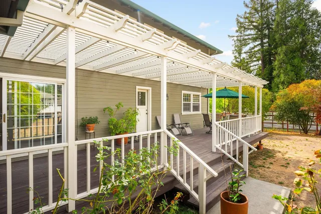 a view of a house with backyard and deck