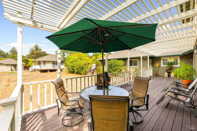 a view of a patio with table and chairs under an umbrella
