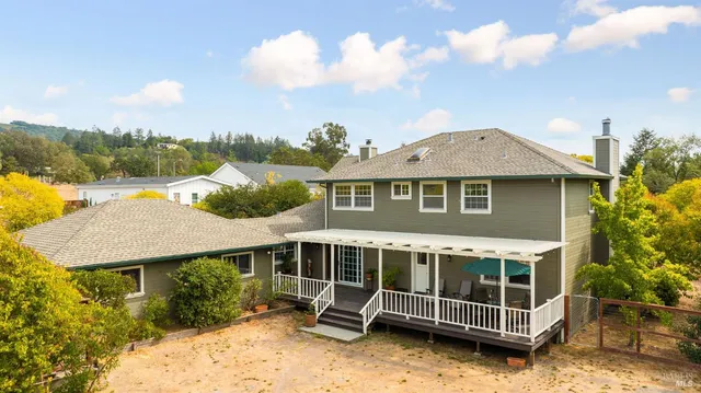 a view of a house with a yard and sitting area