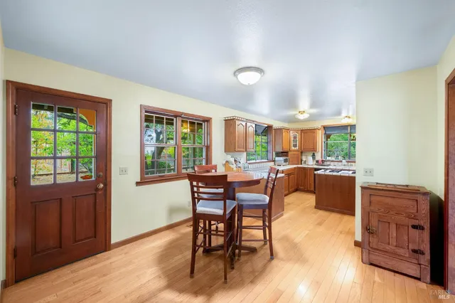 a dining room with furniture and wooden floor