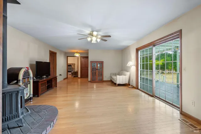 a living room with furniture a flat screen tv and a large window