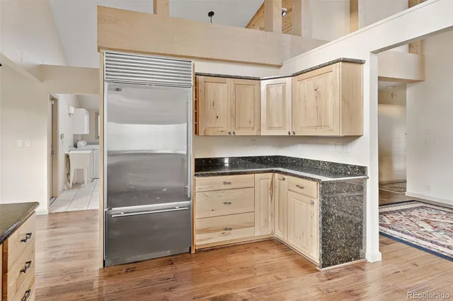 a large white kitchen with granite countertop a sink