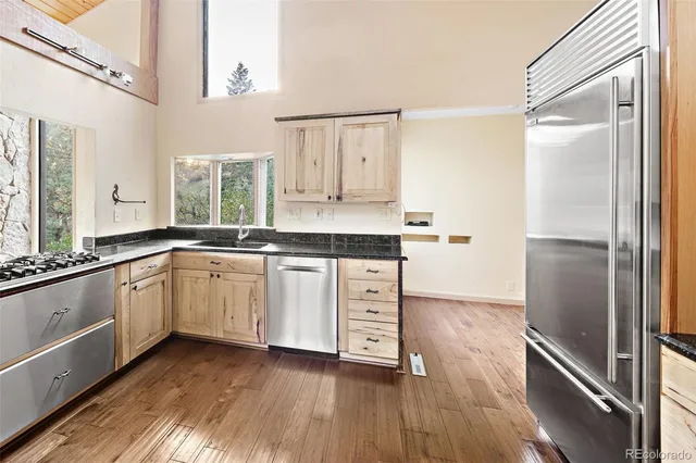 a kitchen with stainless steel appliances granite countertop a stove and a refrigerator