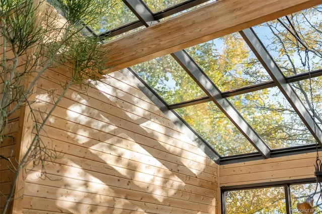 a living room with patio furniture and a floor to ceiling window