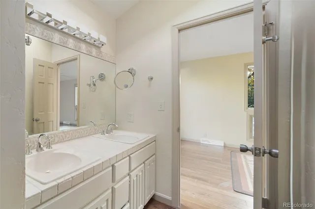 a bathroom with a granite countertop sink and a mirror