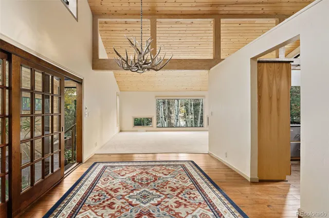 a view of a dining room with furniture and a chandelier