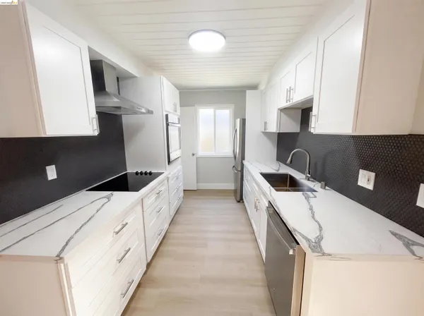a kitchen with a sink a stove and refrigerator