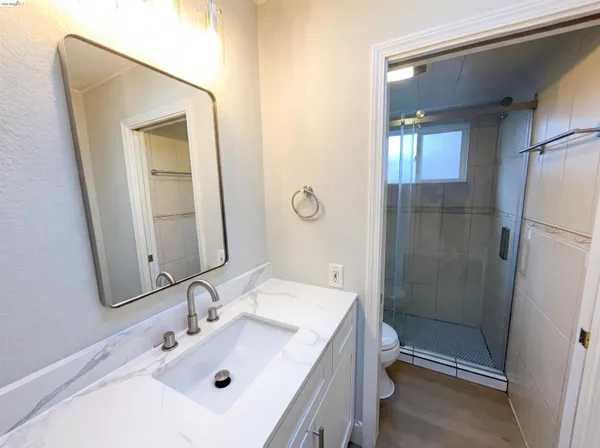 a bathroom with a sink mirror vanity and toilet