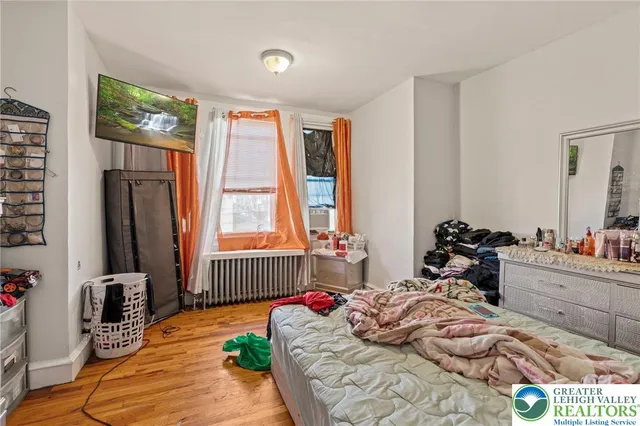 a bed sitting in a bedroom next to a window