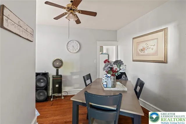 a view of a dining room with furniture and wooden floor