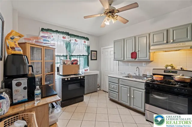 a kitchen with stainless steel appliances kitchen island granite countertop a stove and a sink