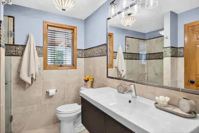 a view of a bedroom with a bed and wooden floor