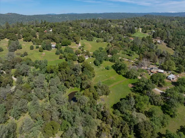 a view of a green field with lots of trees