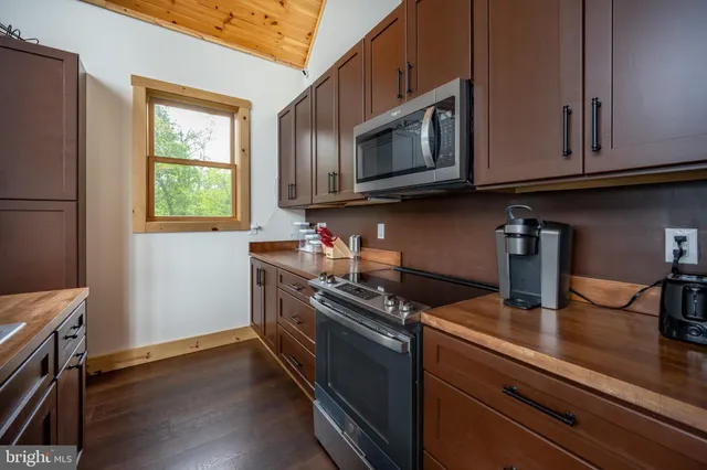 a kitchen with a stove microwave and sink