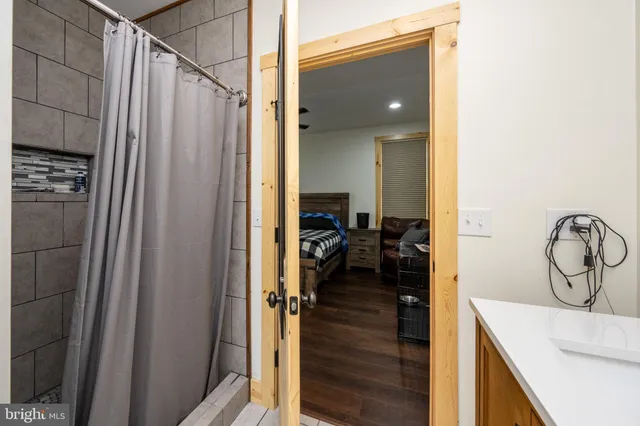 a en suite bathroom with a sink a mirror and a shower