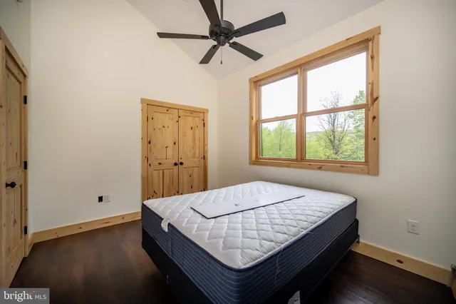 a bathroom with a sink and mirror with wooden floor