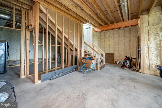 a view of empty room with wooden floor and windows